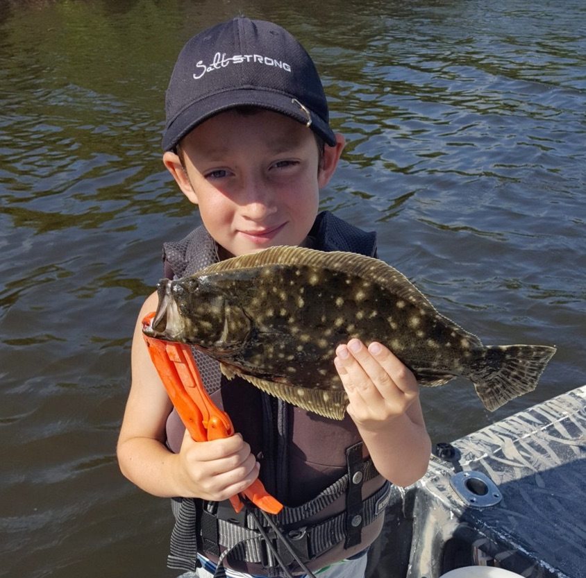 kid catching flounder