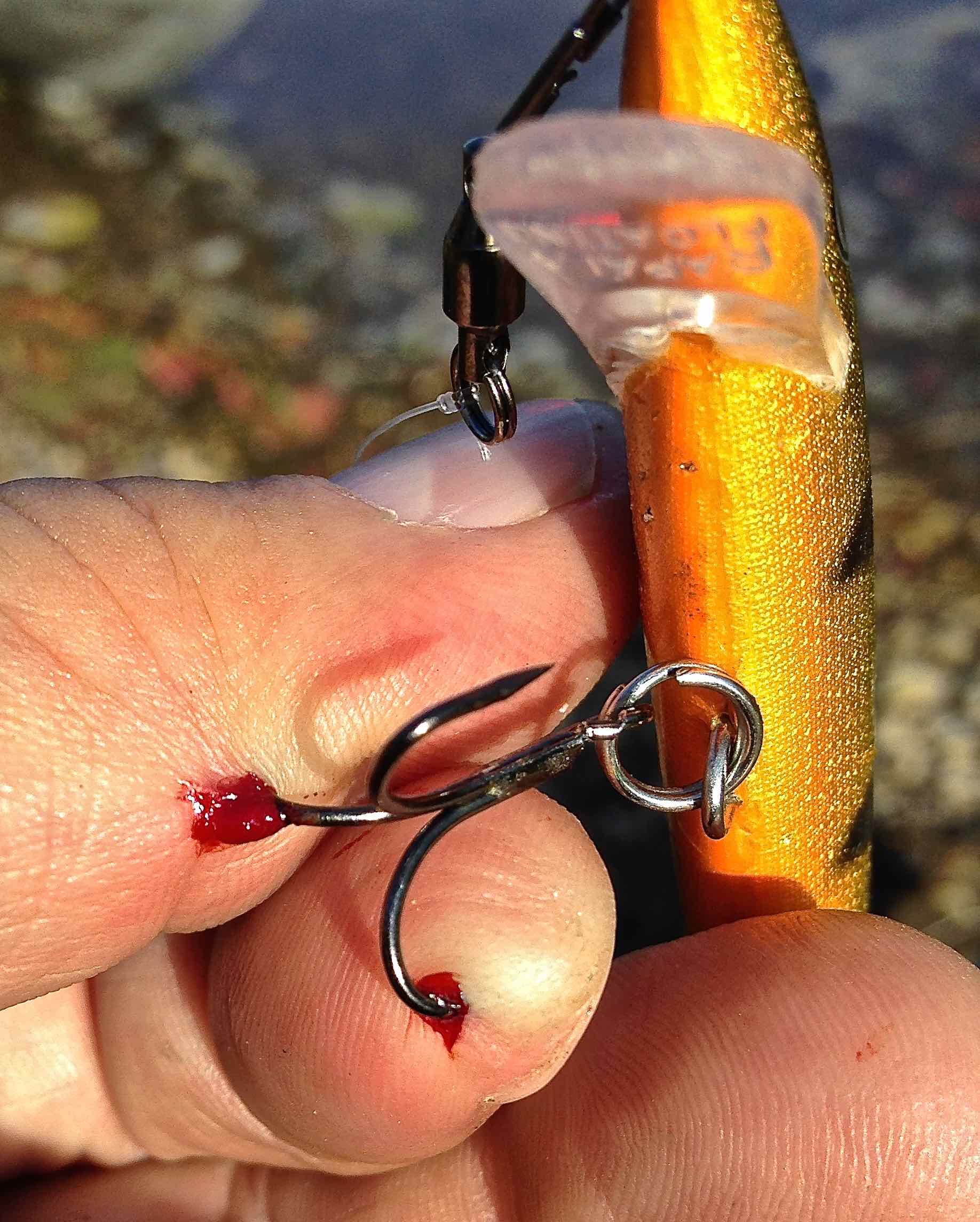 fishing hook in two fingers