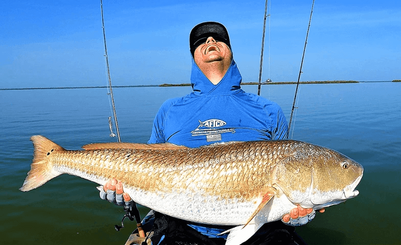 man holding large redfish